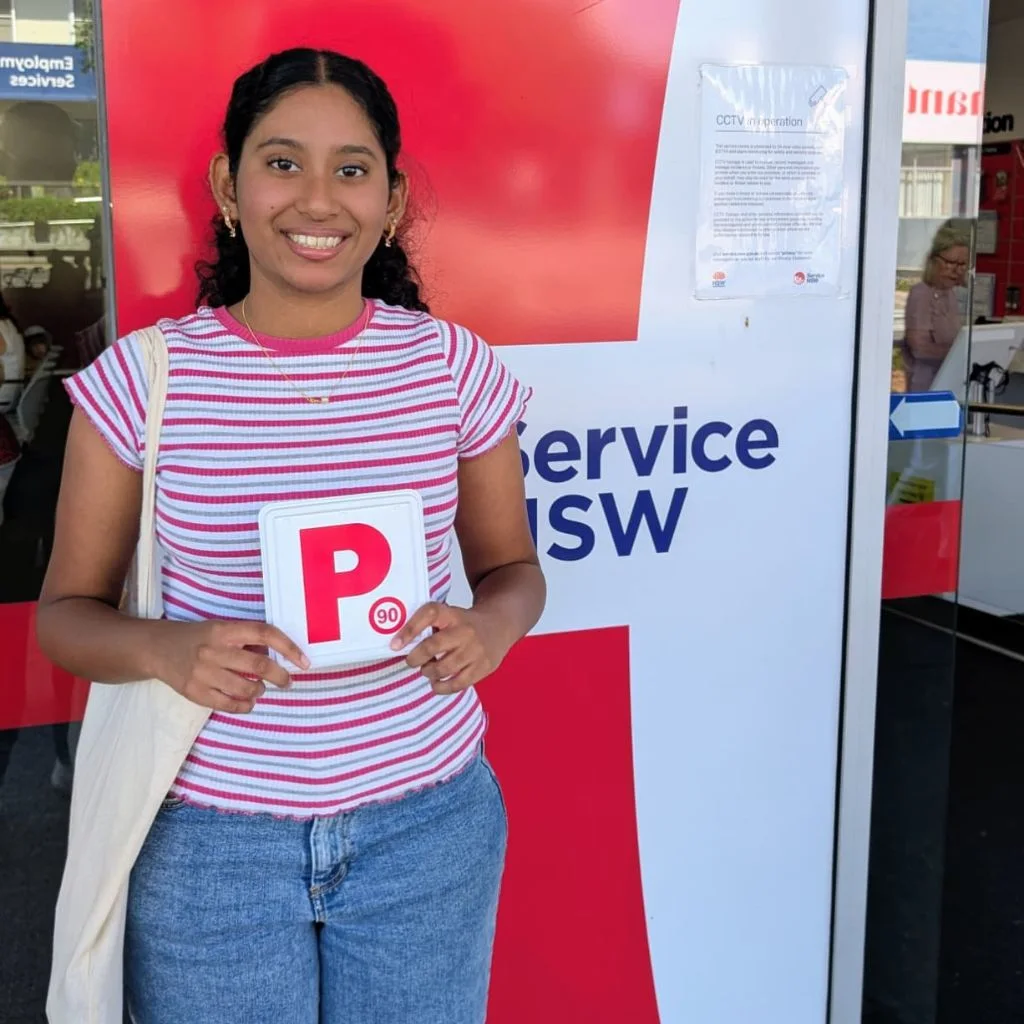 a woman smiling and holding a card