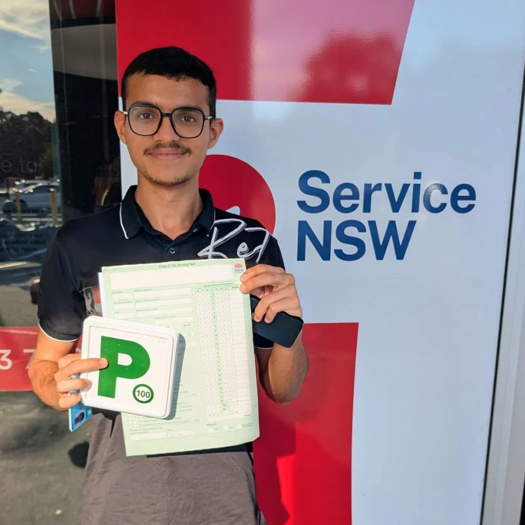 a guy smiling holding his driving license document