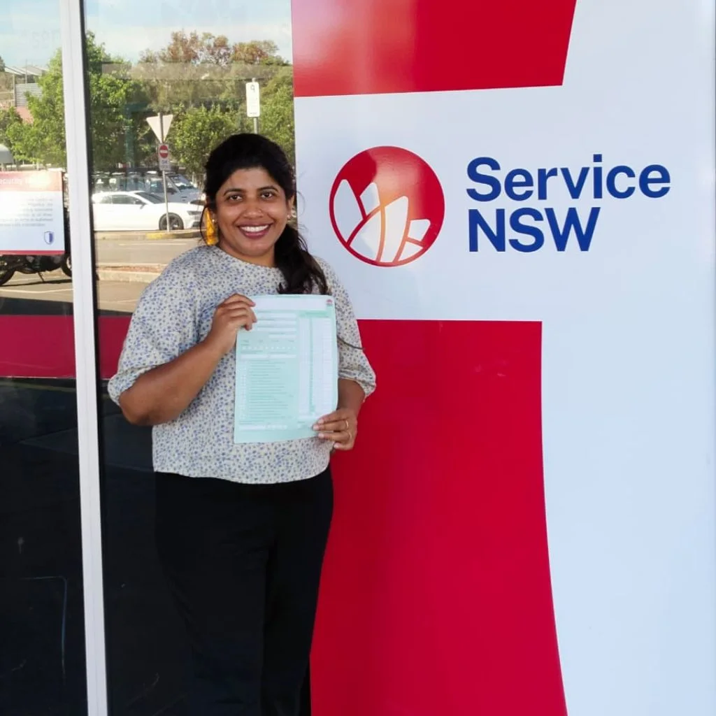a woman smiling and holding a card